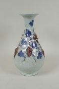 A Chinese crackleware pear shaped vase with raised blue and red grape vine decoration, 25cm high