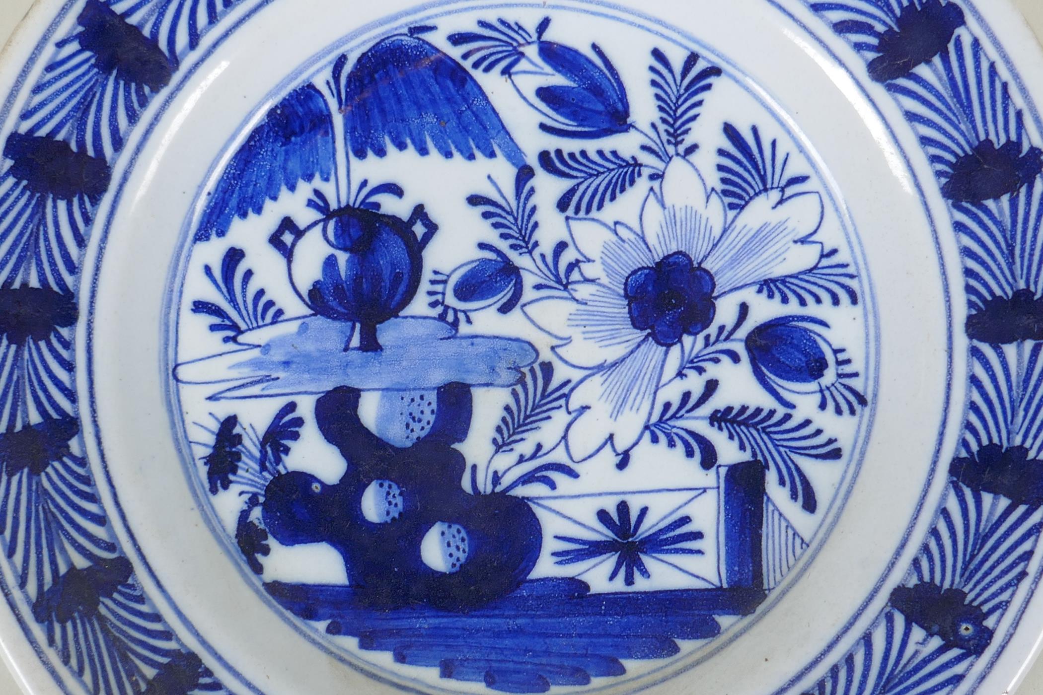 An C18th Dutch Delft blue plate with floral decoration, 23cm diameter - Image 2 of 4