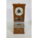 An oak cased National Time Recorder Co clocking-in machine, 34 x 28cm, 88cm high