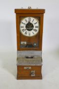An oak cased National Time Recorder Co clocking-in machine, 34 x 28cm, 88cm high