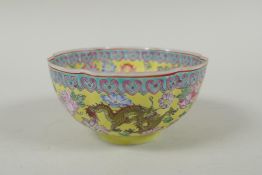 A Chinese famille jaune eggshell porcelain rice bowl decorated with polychrome dragons, TongZhi seal