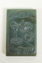 A Chinese spinach jade pendant with carved decoration of crabs and lotus flowers, 4 x 6cm