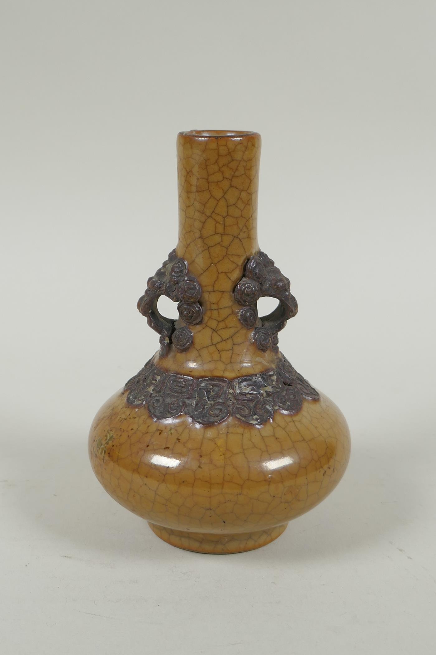 An antique Chinese crackleware bottle vase with two lion mask loop handles, 13cm high