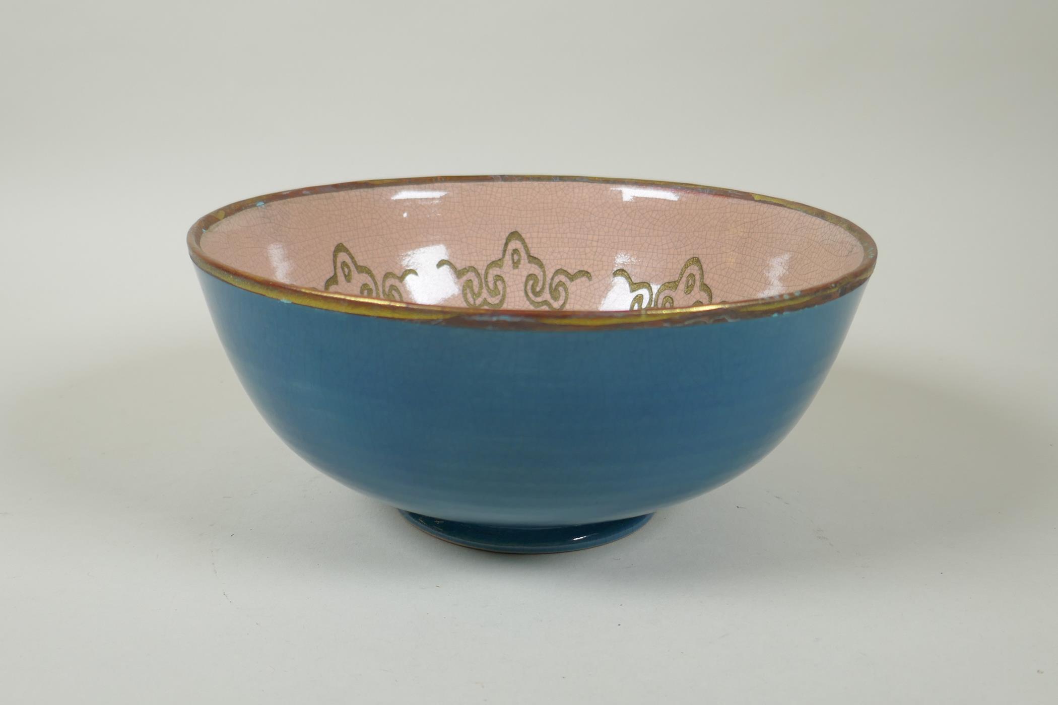 An Oriental teal crackle glazed porcelain bowl with gilt metal rim, the bowl with chased Buddhist