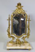 A C19th French ormolu toilet mirror on an onyx base, decorated with putti, swags and torcheres, 66cm