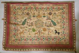 A C19th Indian embroidered wall hanging decorated with depictions of Ganesh, peacocks, elephants,