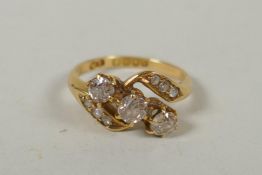 A vintage 18ct gold diamond trilogy twist ring, approx 0.7ct, size P, 4.6g gross