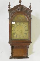 An C18th oak wall clock, the shaped pendant with three finials over a frieze carved with putto's