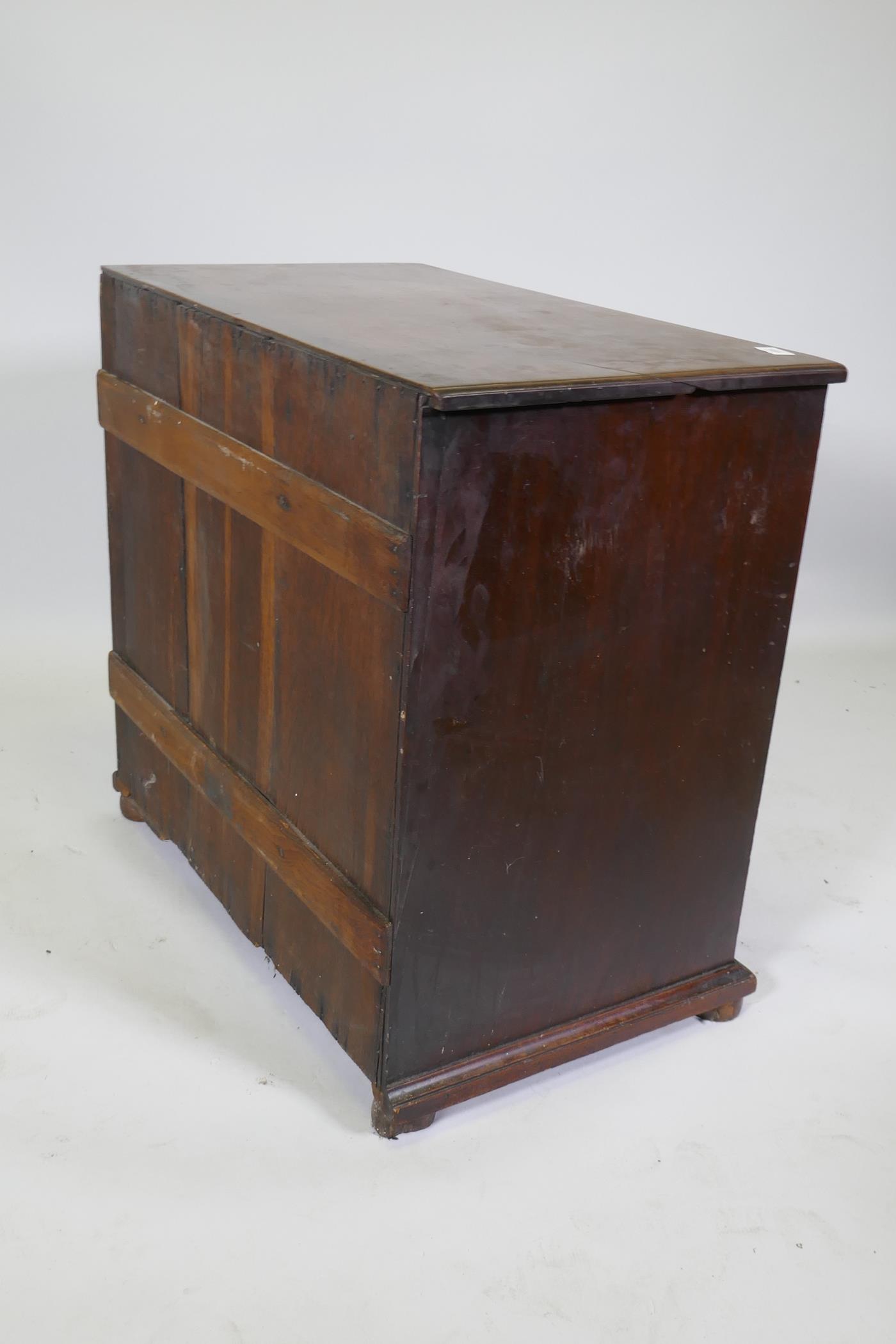 A Georgian mahogany chest of four long drawers under a brushing slide, raised on later bun feet - Image 5 of 5