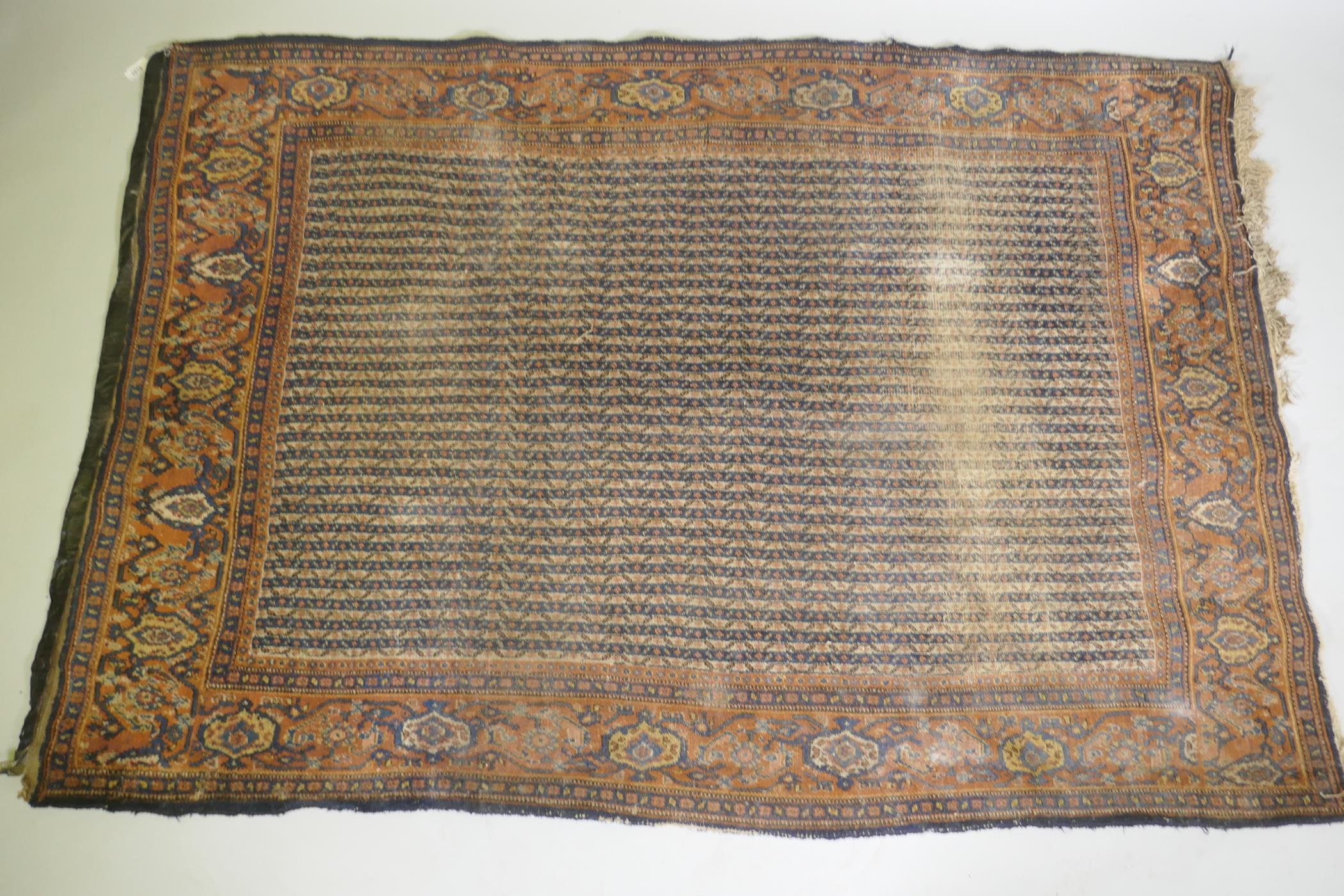 An antique Persian wool carpet with striped design and red borders, worn, 130 x 190