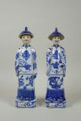 A pair of Chinese Qing dynasty blue and white figures, impressed marks to base, 26cm high