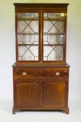 A George III mahogany secretaire bookcase, frieze top and dentil cornice over two astragal glazed