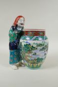 A Japanese Kutani porcelain vase with a figure, the vase decorated with a riverside landscape,
