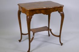 A burr walnut centre table, with shaped top and pull out slides, raised on carved cabriole