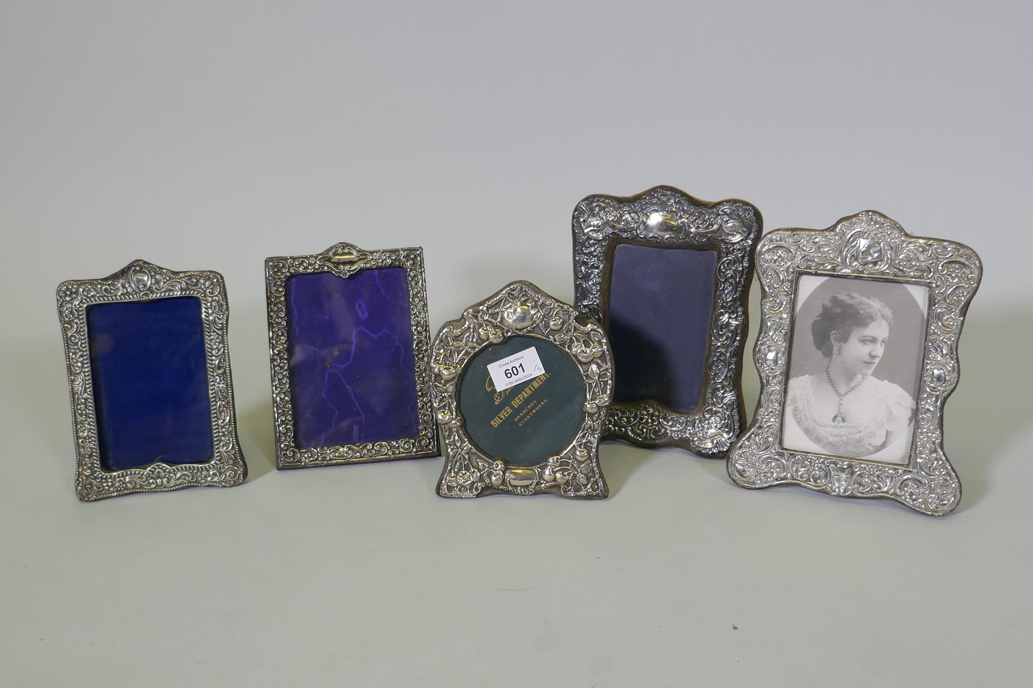 Five antique hallmarked silver photo frames with repousse decoration