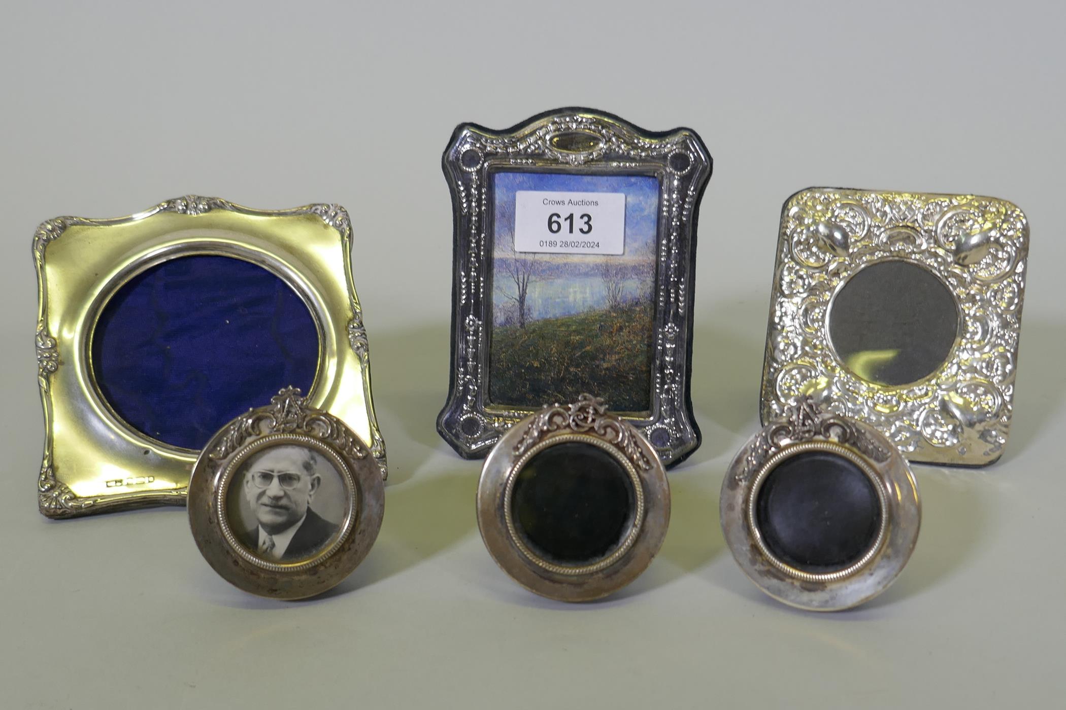 Three miniature silver photo frames with monogram crests, aperture 3.5cm diameter, and three others
