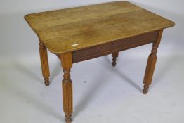 An antique continental oak plank top table, raised on reeded supports, 103 x 74 x 74cm