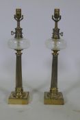 A pair of brass and cut glass table lamps, raised on fluted columns, 60cm high