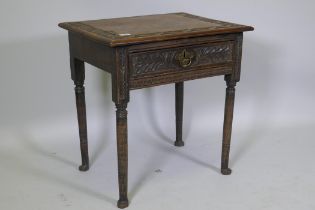 A Georgian oak single drawer side table with carved, raised on turned supports with pad feet, 66 x