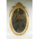 An antique French oval gilt mirror, with bevelled antique glass, 53 x 87cm