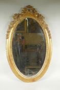 An antique French oval gilt mirror, with bevelled antique glass, 53 x 87cm