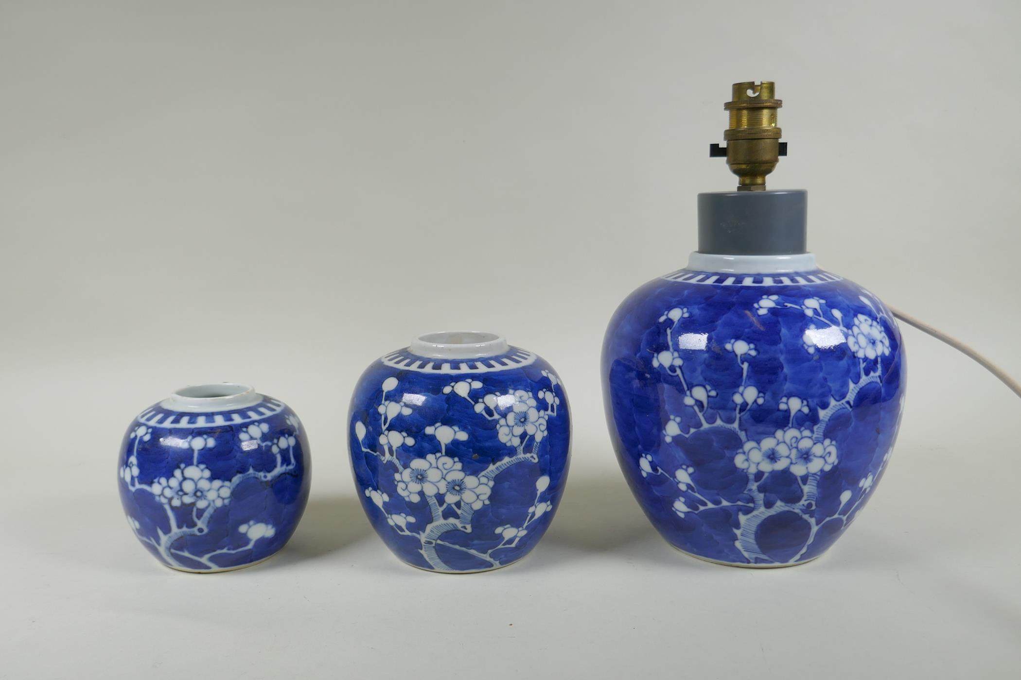 Three Chinese blue and white porcelain graduated ginger jars, decorated with prunus blossom on a
