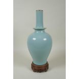 A Chinese Ru ware style porcelain vase, on a carved wood stand, 33cm high