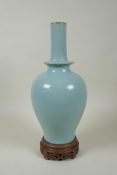 A Chinese Ru ware style porcelain vase, on a carved wood stand, 33cm high