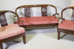 A Chinese hardwood settee with scroll arms, and matching armchairs