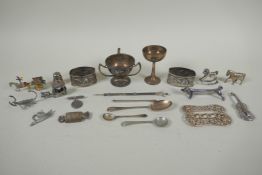 A quantity of silver items to include belt buckles, napkin rings, cups, knife rests, etd, 230g,