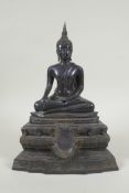 A Thai bronze figure of Buddha seated on a tiered throne,