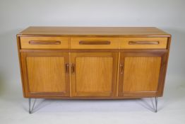 A mid century G-Plan Fresco sideboard/buffet, with three drawers over three cupboards, raised on