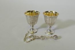 A pair of hallmarked silver gift egg cups with Gothic style decoration, marked John Samuel Hunt,