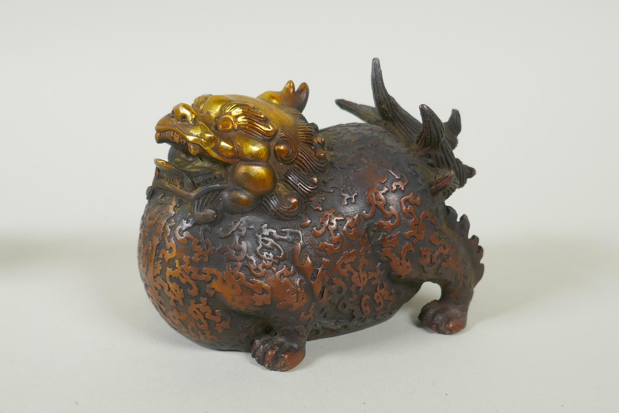 A pair of Chinese filled bronze kylin with gilt heads, 11cm long - Image 4 of 5
