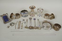 A quantity of hallmarked silver to include napkin rings, egg cup, salt pot etc, and a quantity of