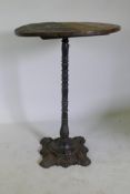 An antique cast iron pub table with wood top, 72cm diameter, 102cm high