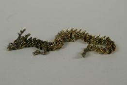 A Japanese Jizai style bronze okimono dragon, with articulated body and legs, 23cm long