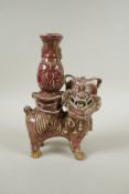 A Chinese flambe glazed porcelain spill vase in the form of a temple lion, 23cm high
