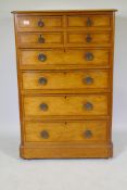 A Victorian polished pine chest of drawers with original painted decoration, four over four