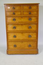 A Victorian polished pine chest of drawers with original painted decoration, four over four