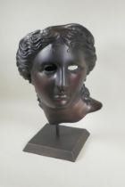 A bronze head bust/mask of Aphrodite, on a display stand, 43cm high