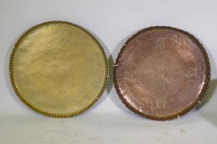 A large Indo/Persian copper tray, 64cm wide, and a brass tray with Islamic calligraphy decoration