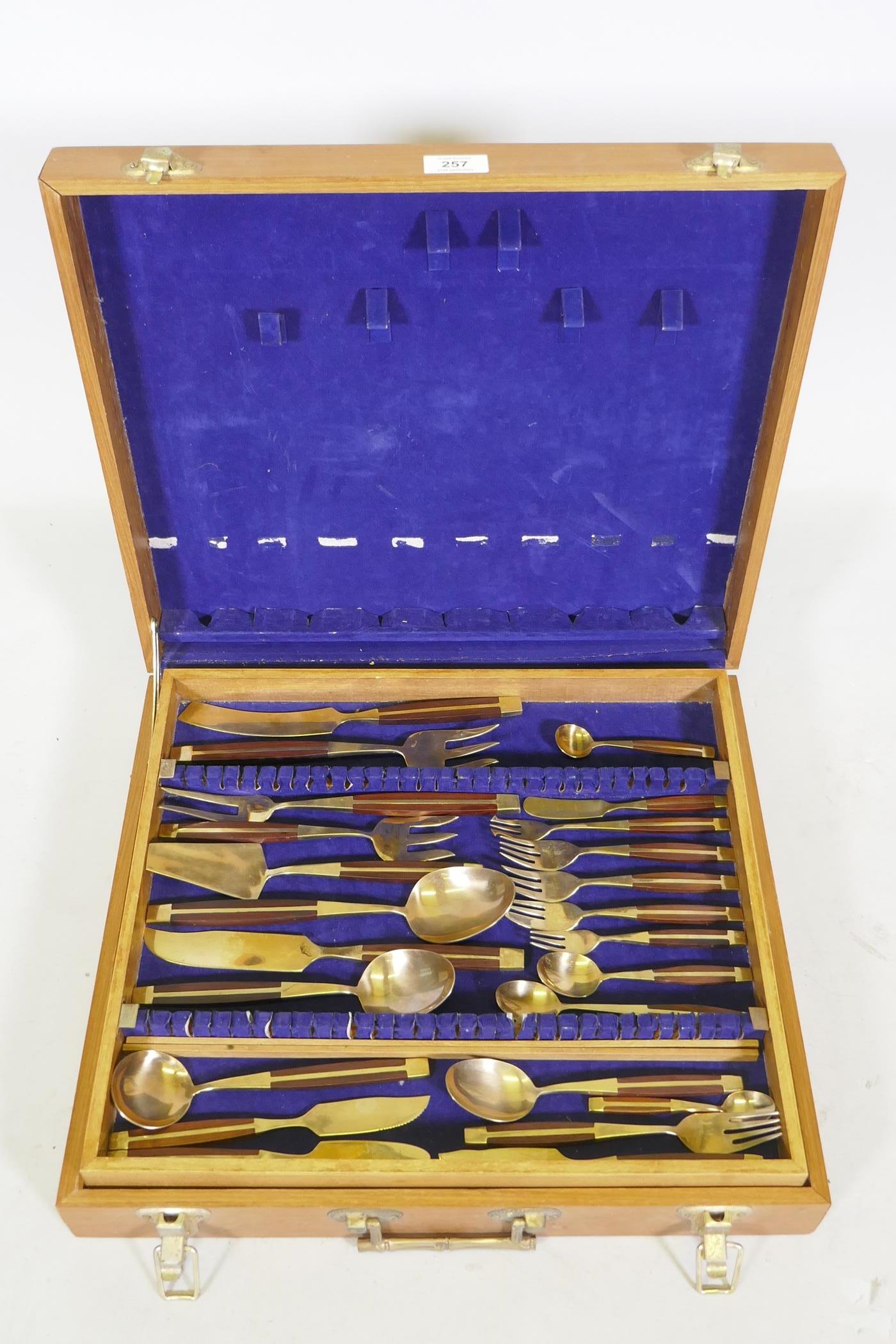 A canteen of brass and rosewood cutlery, probably Thai or Malaysian, 12 place settings