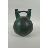 A South American double spout  and bridge ceramic bottle with bronze style glaze, 25cm high