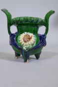 A Chinese Sancai glazed terracotta ding censer, with moulded decoration, on tripod supports, 17cm