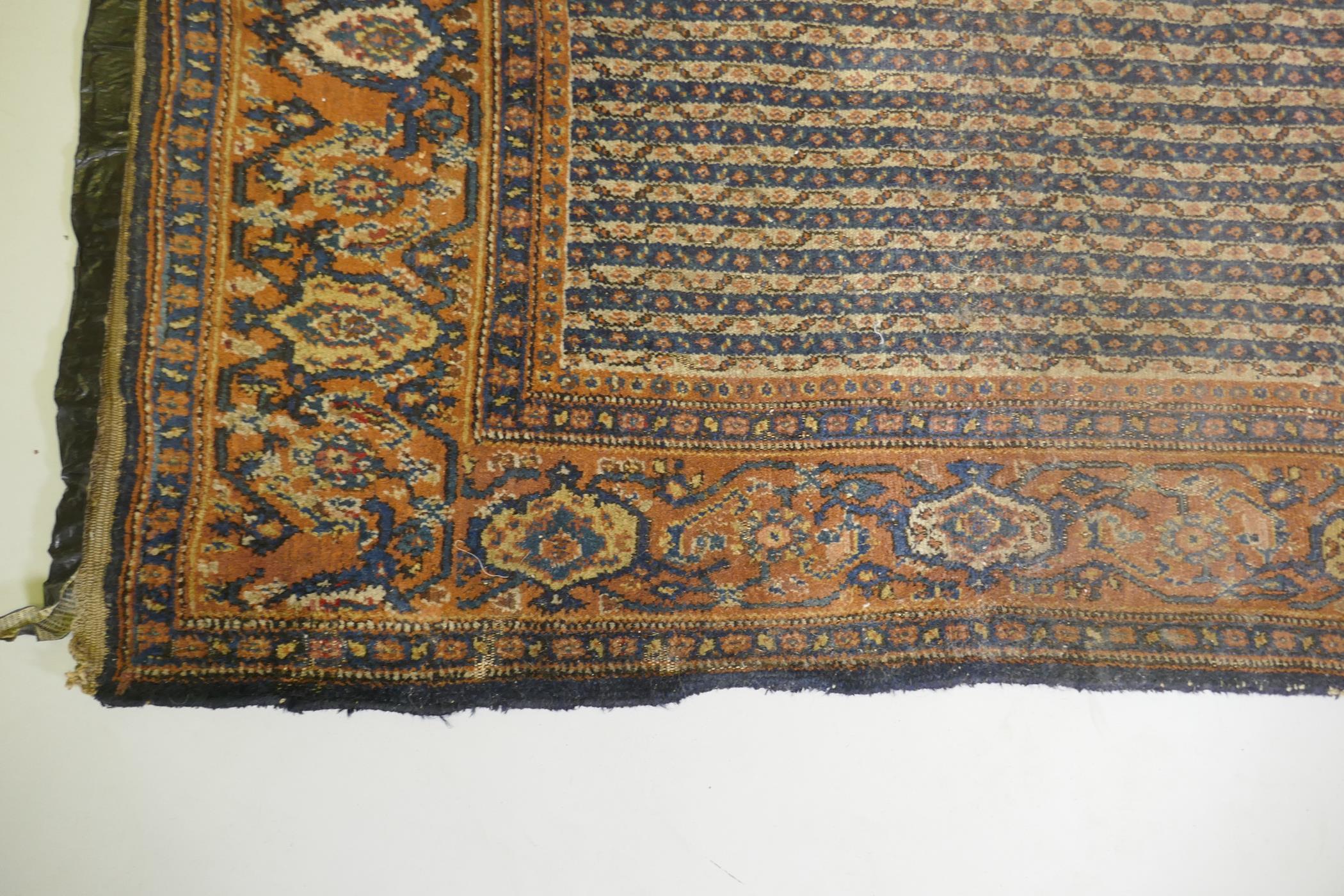 An antique Persian wool carpet with striped design and red borders, worn, 130 x 190 - Image 2 of 3