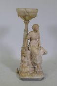 An early C20th alabaster lamp in the form of a young woman seated upon a rock, on a marble base