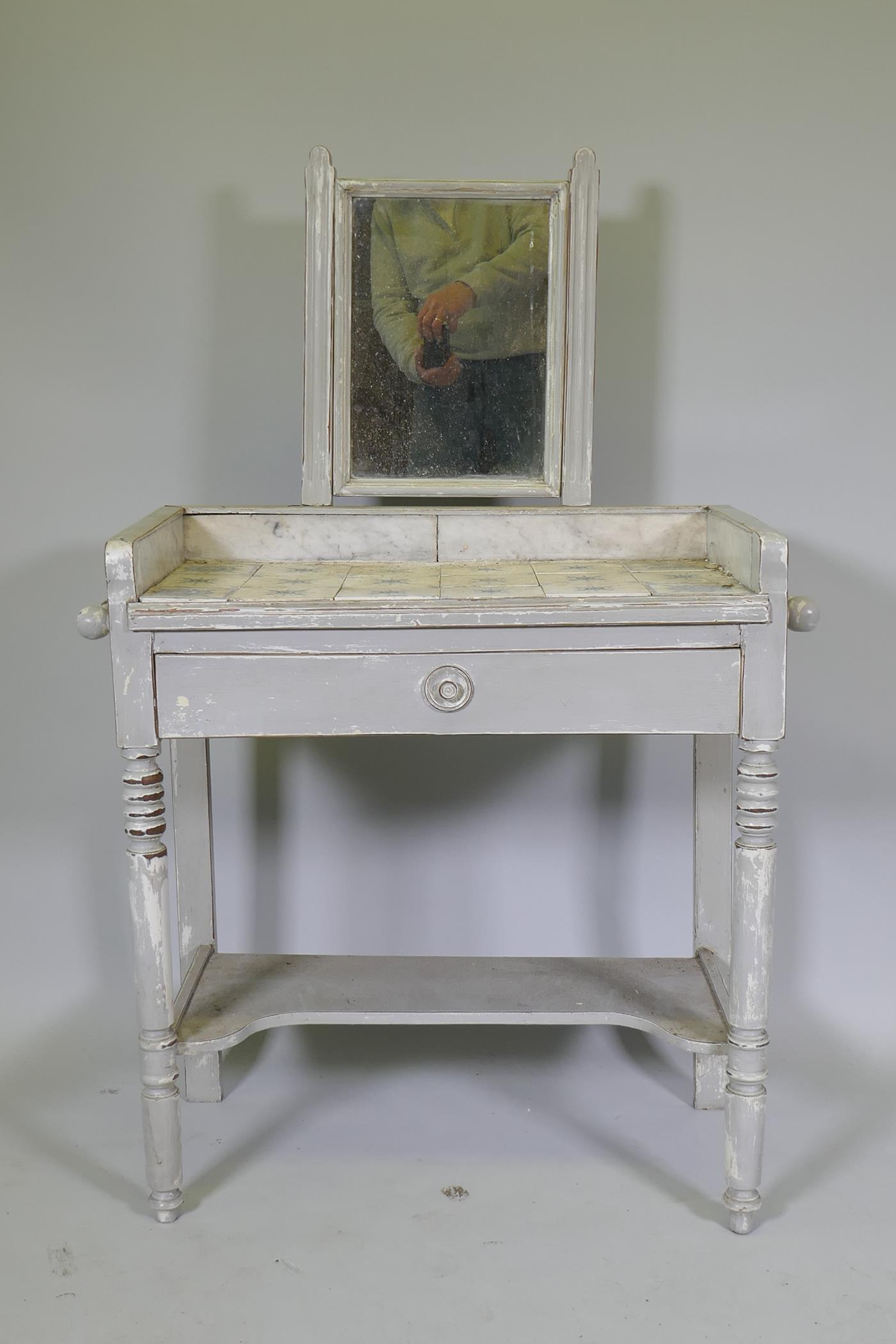 A C19th French painted dressing table, with swing mirror and three quarter marble gallery tiled