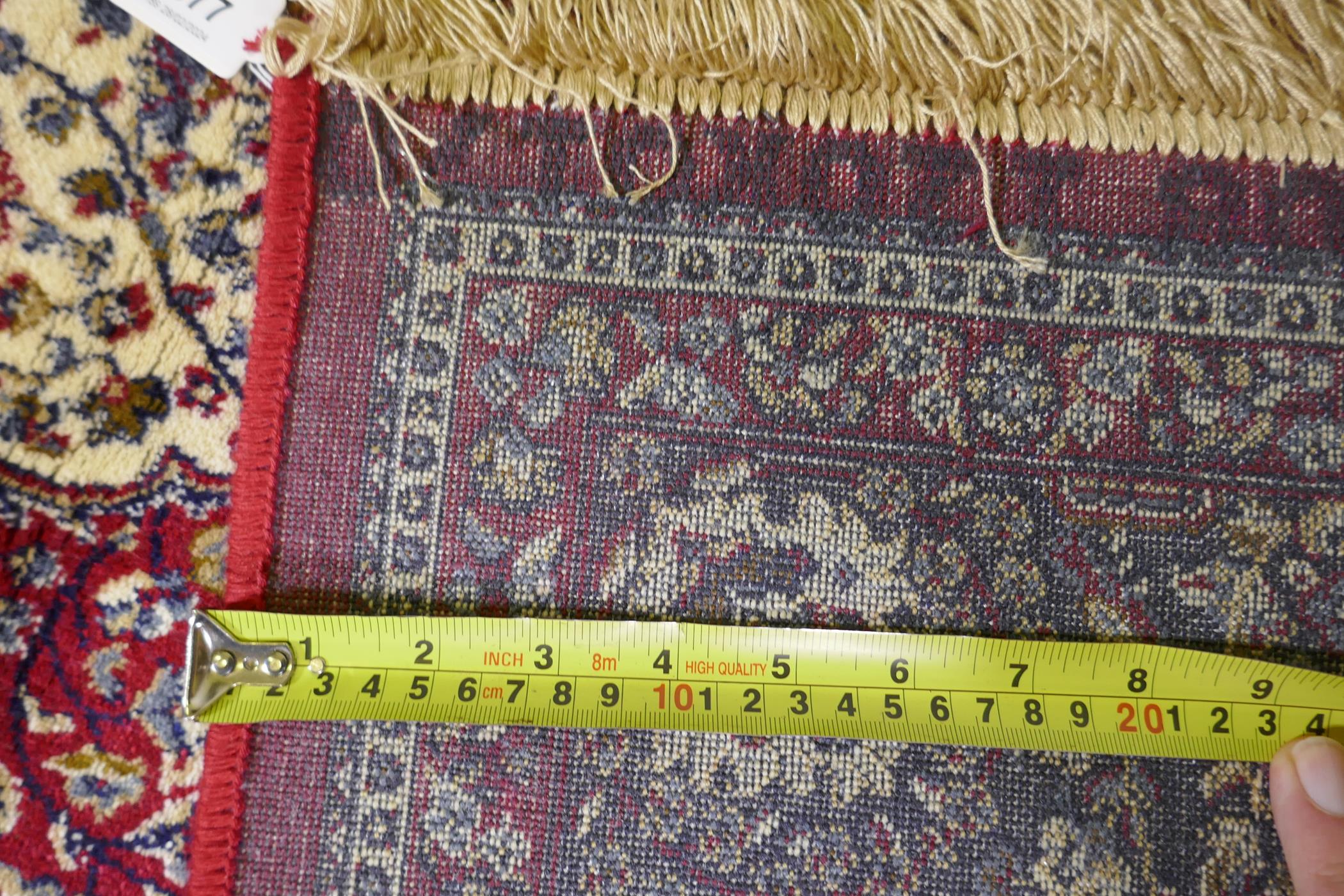 A red ground Kashmir rug with traditional floral medallion design and blue borders, 170 x 120cm - Image 5 of 5