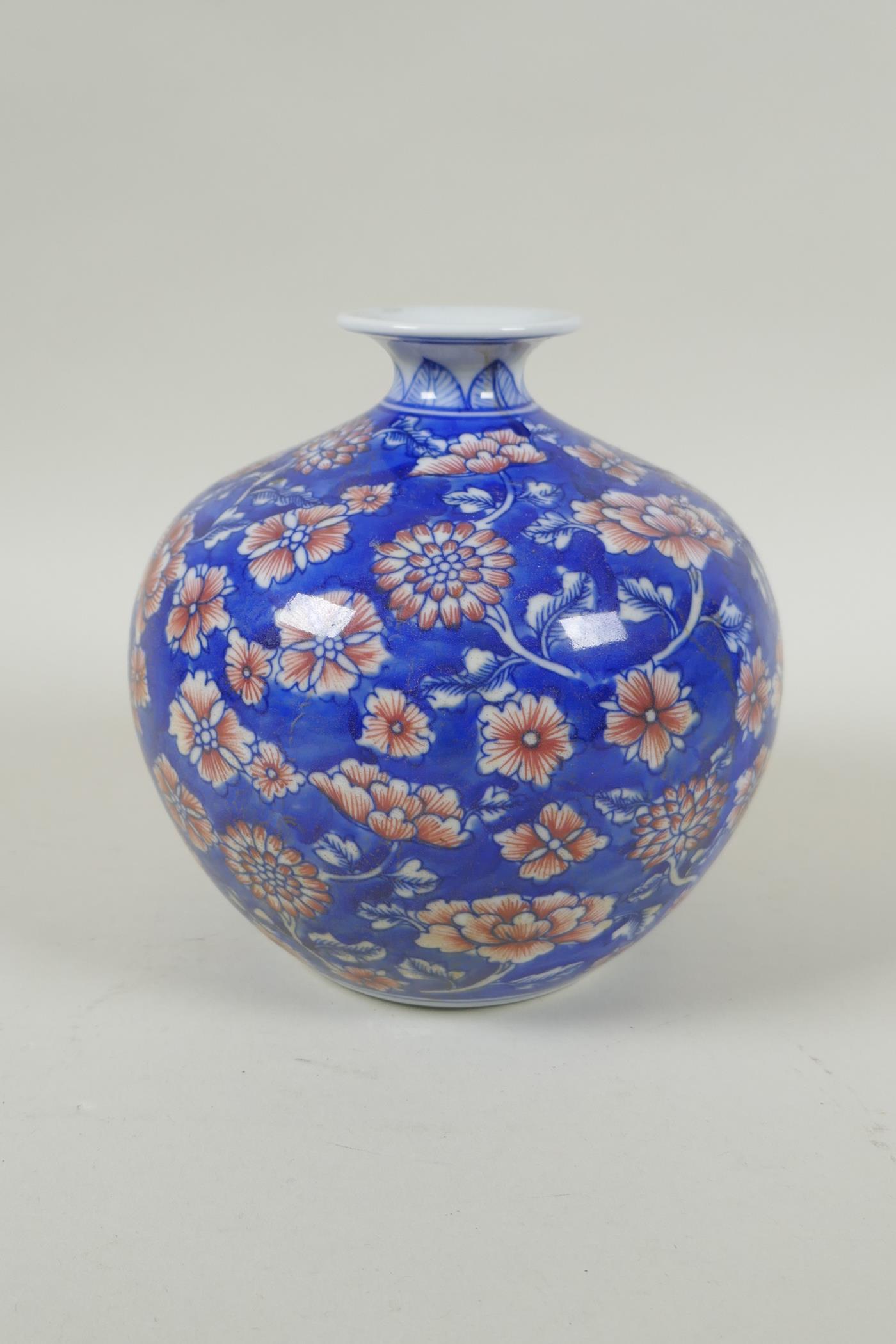 A Chinese blue and white porcelain pomegranate shaped vase, with allover floral decoration and red - Image 2 of 5